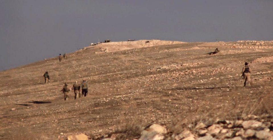  Gunmen walking in an area east of Palmyra city, in Homs, Syria where they have regained control