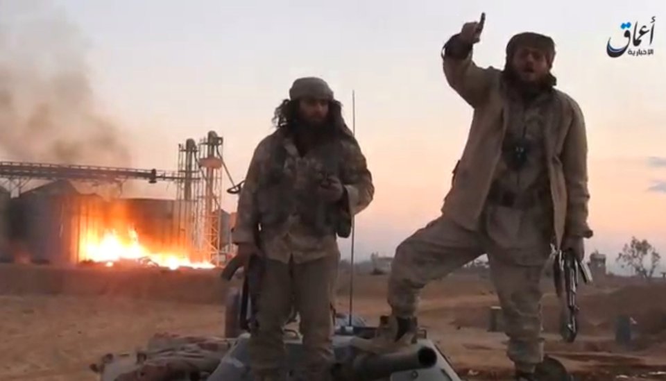  IS fighters celebrate victory in a video released by a news agency affiliated with them