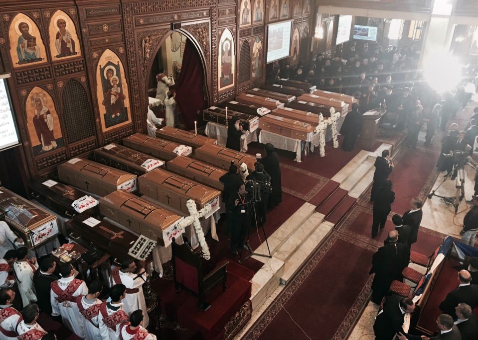  Coffins adorned with crosses can be seen laid out during the funeral