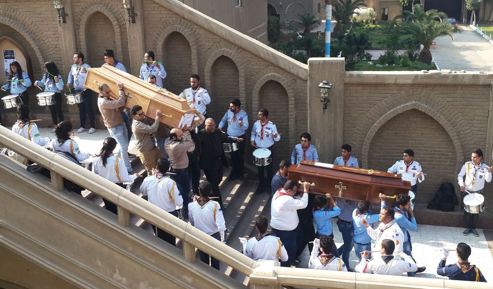  Egyptians carry the coffins of the victims of yesterday's bombing to be laid to rest