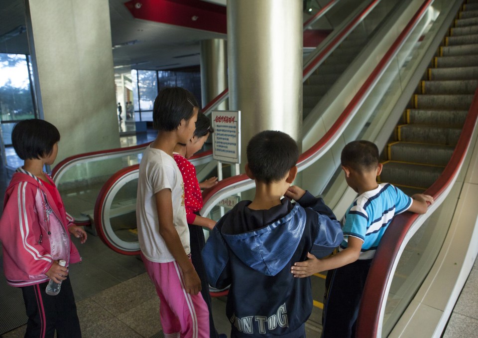 Eric said:: "The Pionners camp of Wonsan is often visited by tourists to show the youth from all over the country having fun. But some children come from the countryside and are afraid to use the escalators which they've never seen before."