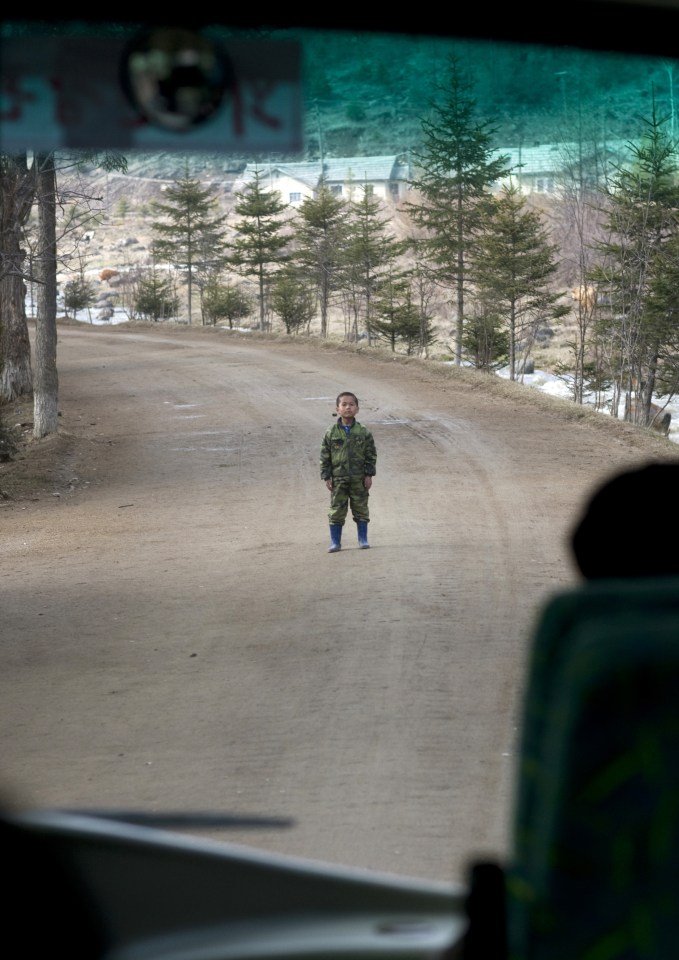 Eric explained: "A rare example of an undisciplined kid in North Korea. The bus was driving in the small roads of Samijyon in the north, when this kid stood in the middle of the road."