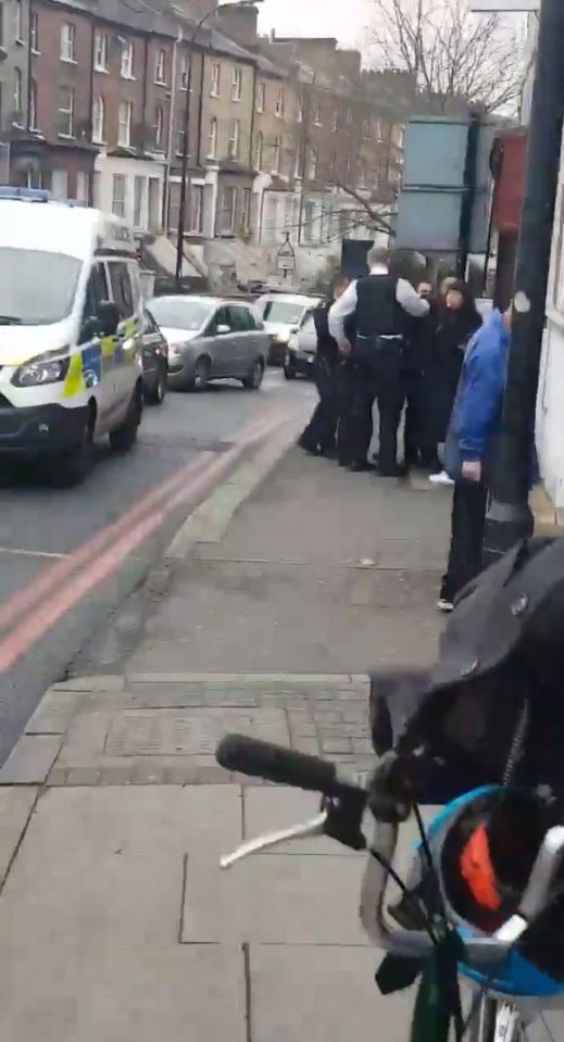  Police surround a man near the scene of the attack