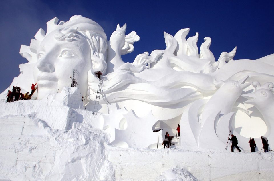  Dozens of artists carry out painstaking work to complete the giant ice sculpture in time for the annual snow festival