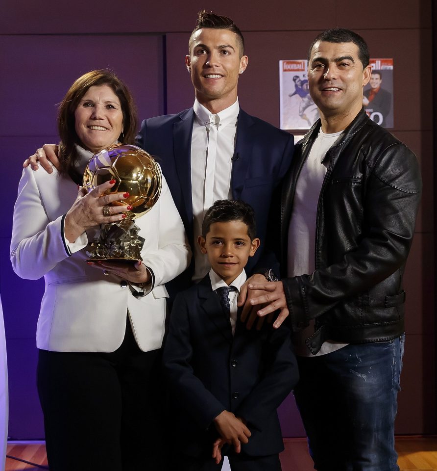 Cristiano Ronaldo gives his Ballon dOr award to mum Dolores to hold as he poses with sone Cristiano Jr