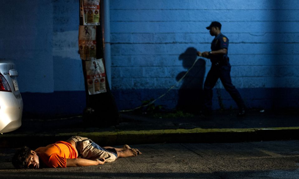  The bodies of victims are left motionless in the street following the execution-style killings