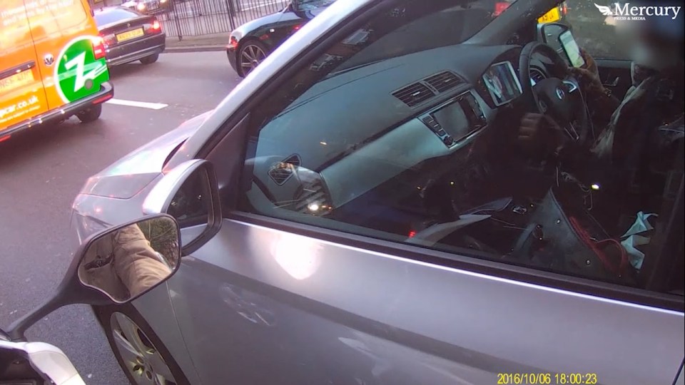 The woman was spotted tapping away on her phone and watching her tablet while driving through London