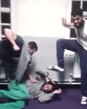  A group of inmates are seen pretending to beat another up during the mannequin challenge