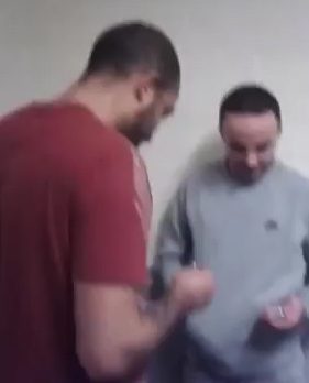  Two men are caught looking like they are dealing in some kind of contraband, before the camera quickly moves away