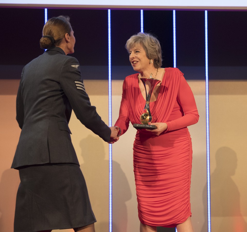  PM Theresa May shakes hands with a winner from the Hero Overseas Unit