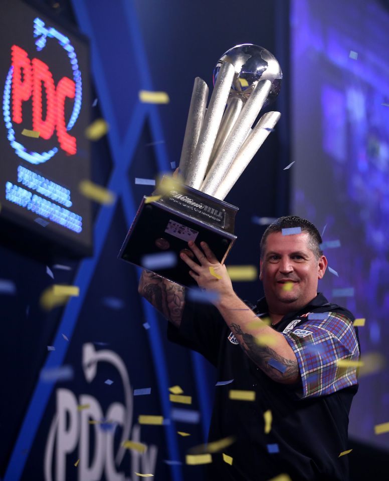 Anderson lifts the trophy after his world title win at the beginning of this year