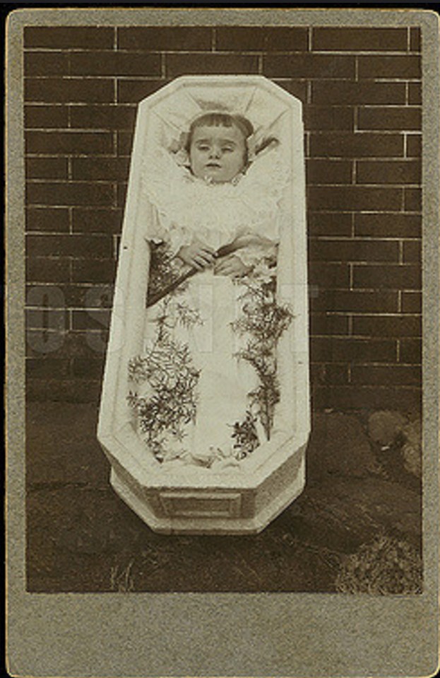  In this image, a little girl is seen in her coffin