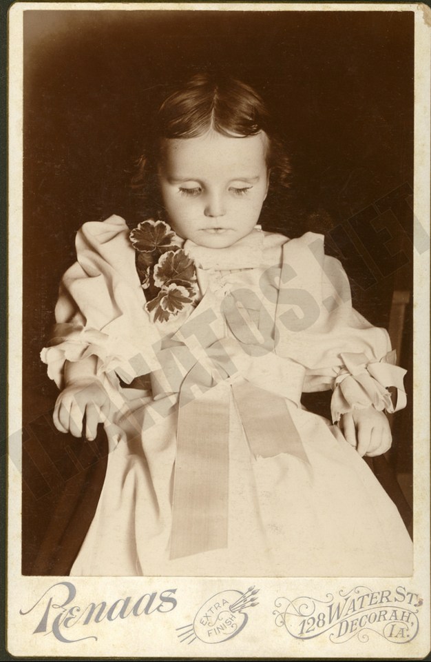  A little girl is propped up in a chair shortly after passing away in a photograph taken around 1890 in Iowa, US