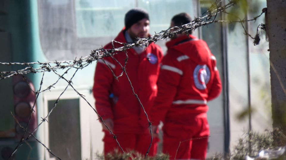  Humanitarian worker from the Syrian Red Crescent wait to help people evacuate the area