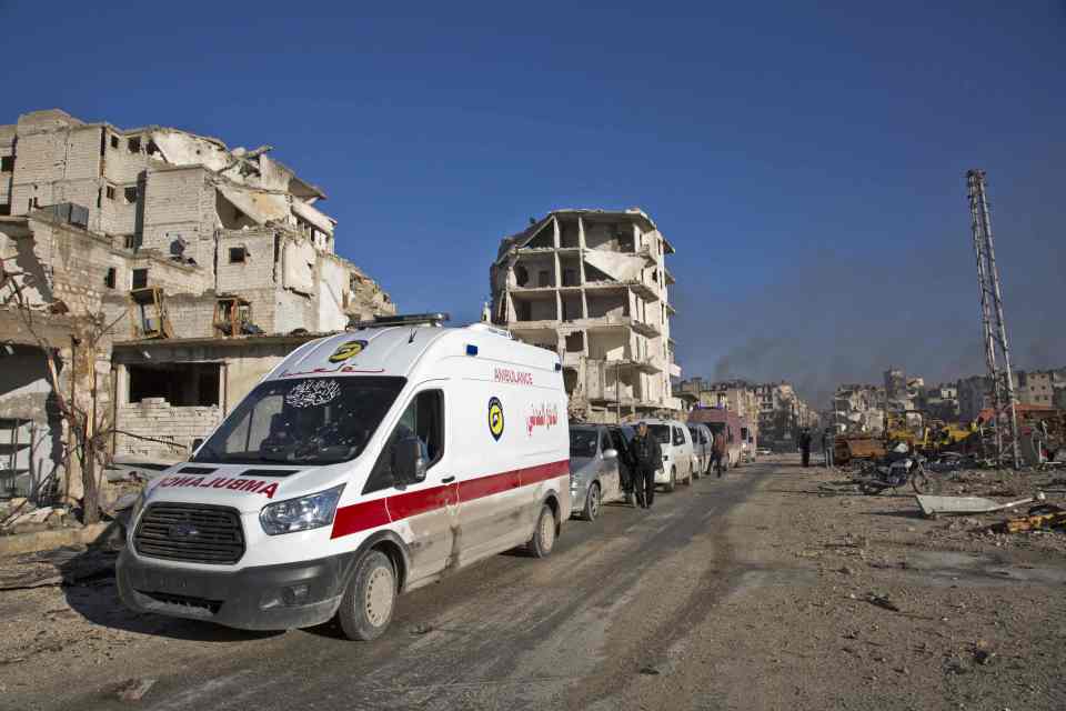  Wounded Syrian civilians and their families gather at the rebel-held al-Amiriyah neighbourhood as they wait to be evacuated to the government-controlled area of Ramoussa