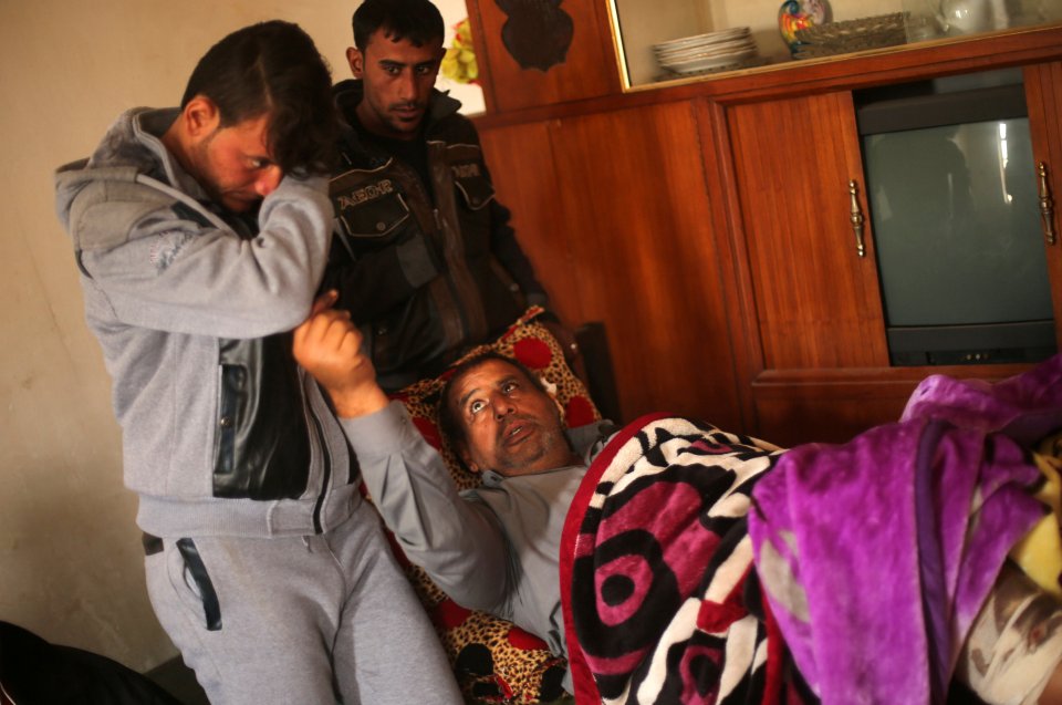  Azad, left, stands beside his father, who was injured in an explosion