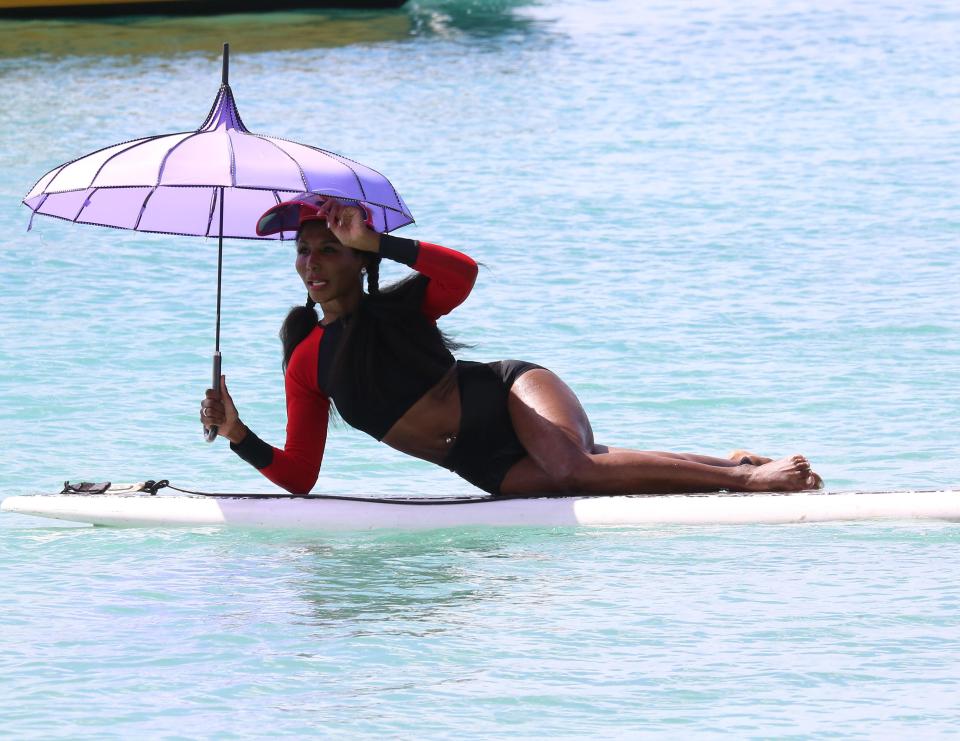  She was spotted out on a paddle board wearing a wet suit and a sun visor