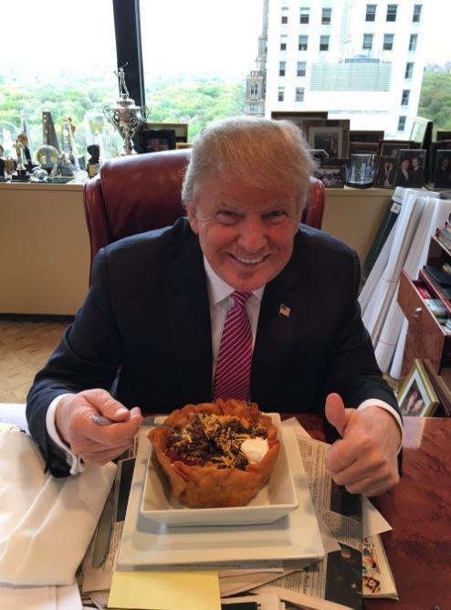  Donald Trump has hit back after a scathing review criticised his Trump Grill restaurant. The President-elect is pictured here with one of the joint's tacos