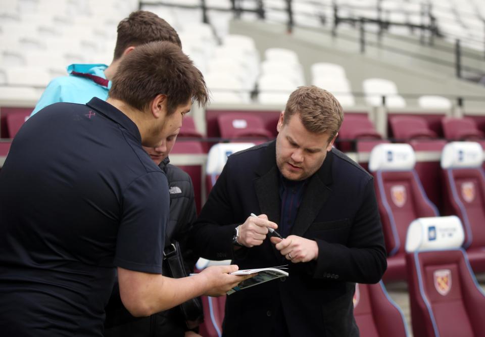  Actor James Corden signs autographs for fans before the match