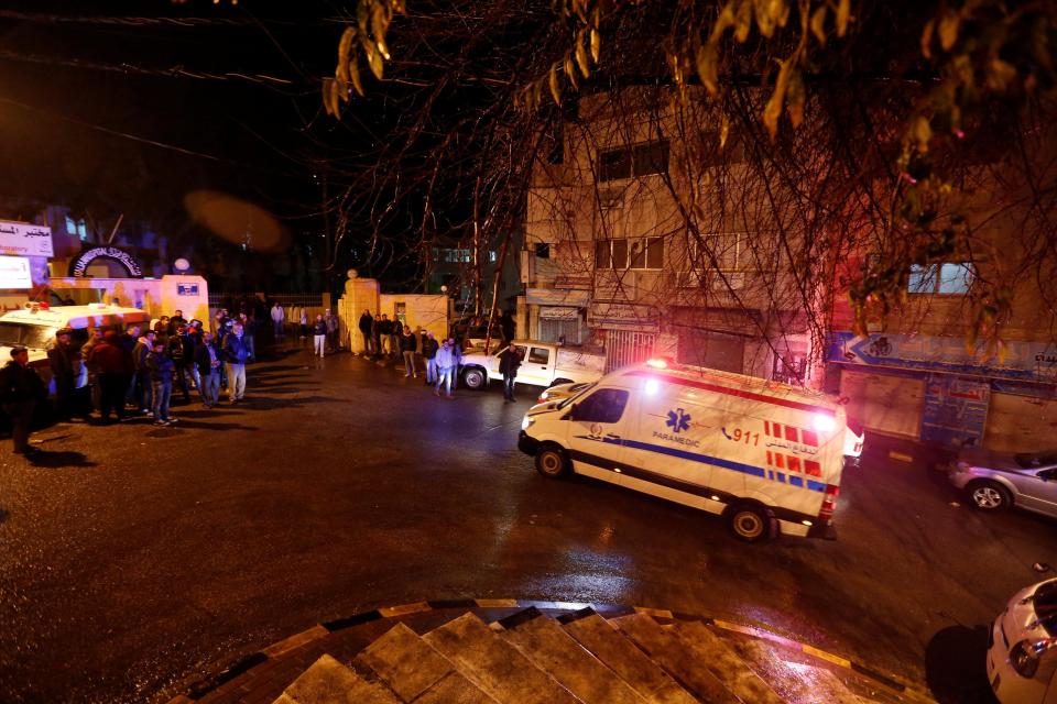  An ambulance drives through the area where ten people were killed