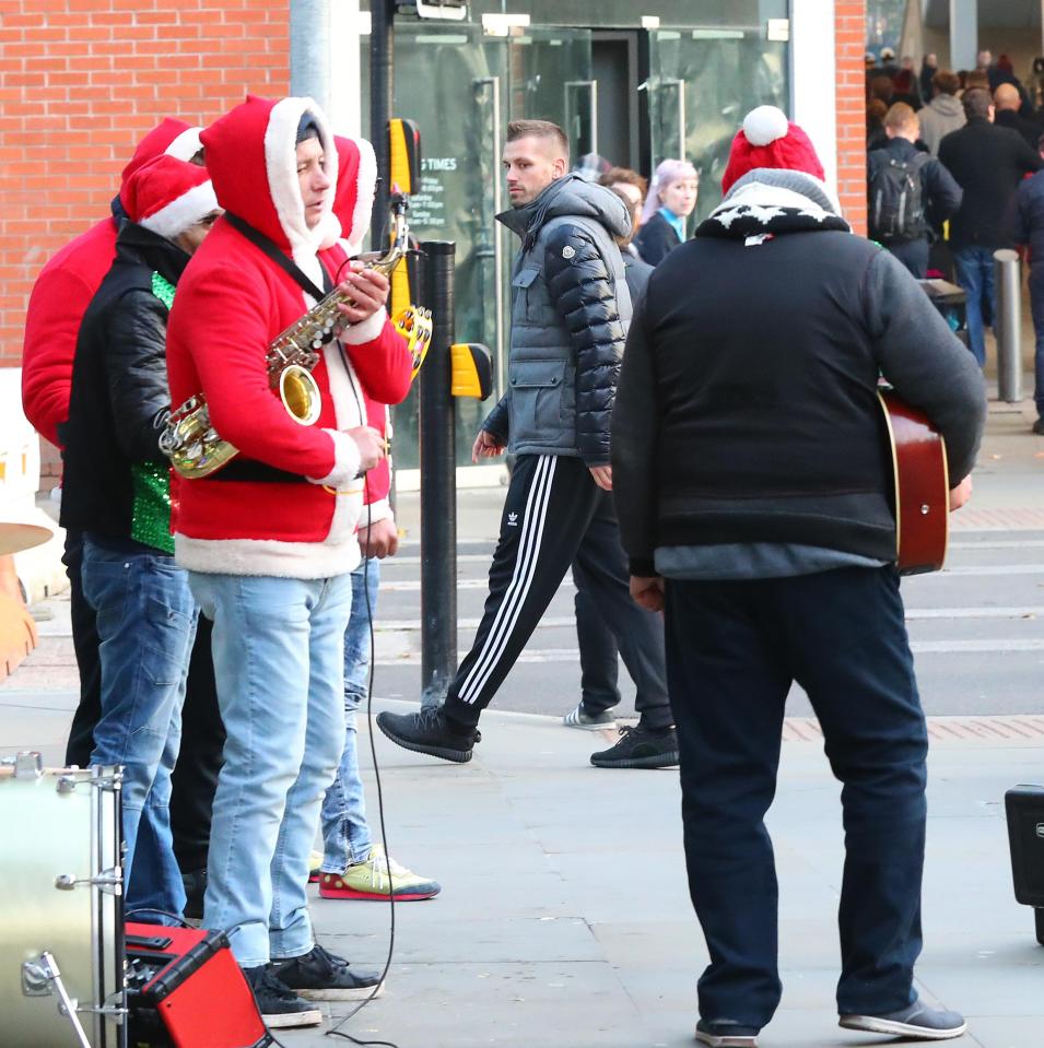 Shoppers and buskers seem none the wiser to the Manchester United player