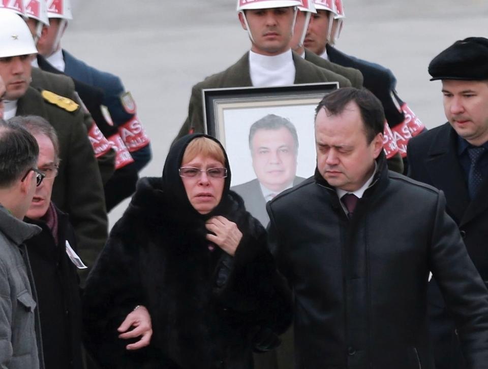  Mr Karlov's wife is accompanied by officials and family