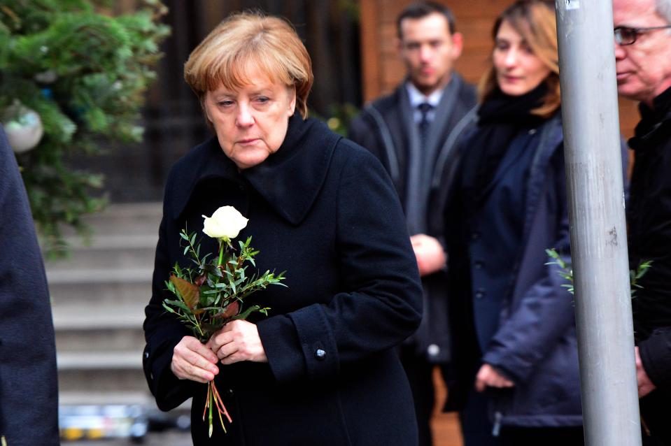  The German chancellor looked tearful as she laid white roses at the scene of the atrocity in Breitscheidplatz, Berlin