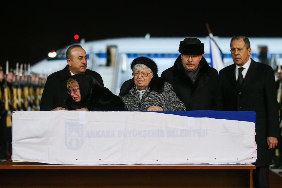  Karlov's mother and grieving widow cry over his coffin as his body arrives back in Russia