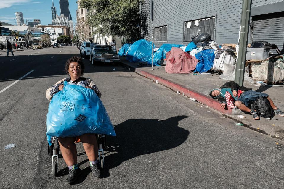 T gathers clothing donations from church groups at Christmas to bring them to a building for elderly, housebound people in Skid Row