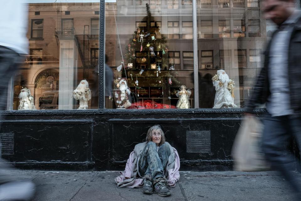 L sits on 5th Street between Los Angeles Street and Main Street...she's exhausted from pushing a large shopping cart full of her belongings