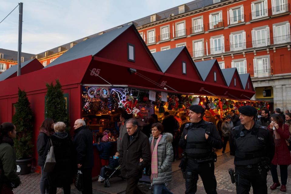 Local policemen patrol a Christmas market at the Plaza Mayor in Madrid, Spain