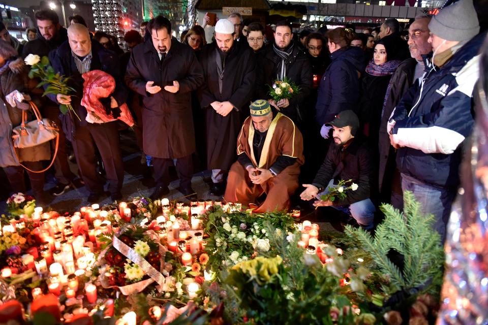  Candles and written and floral tributes were left in the square today, while Angela Merkel attended a memorial service in the adjacent church