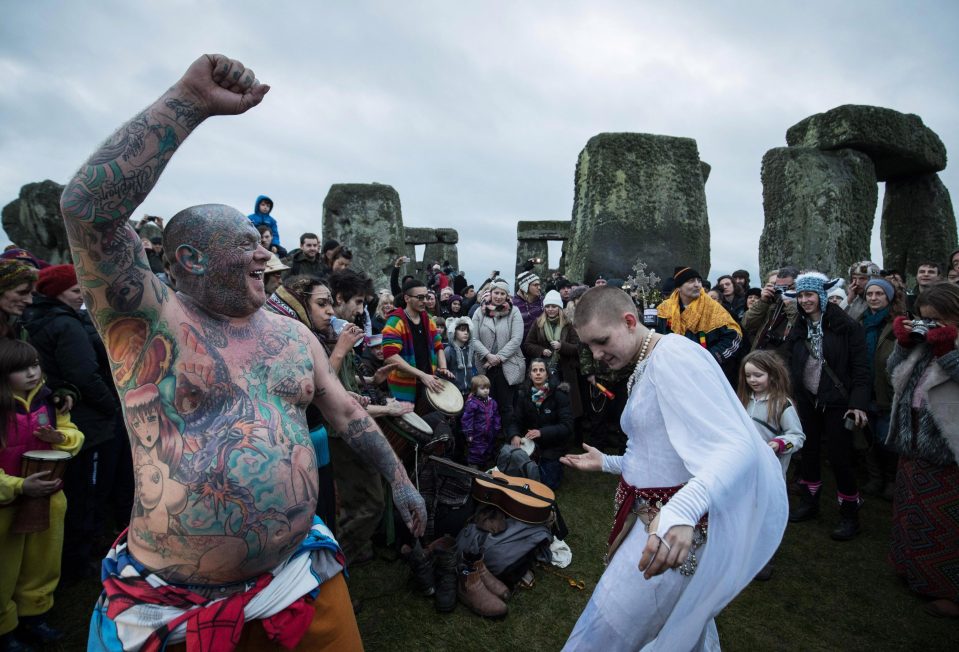  Solstice reveller Mad Al dances with for the crowds during the solstice