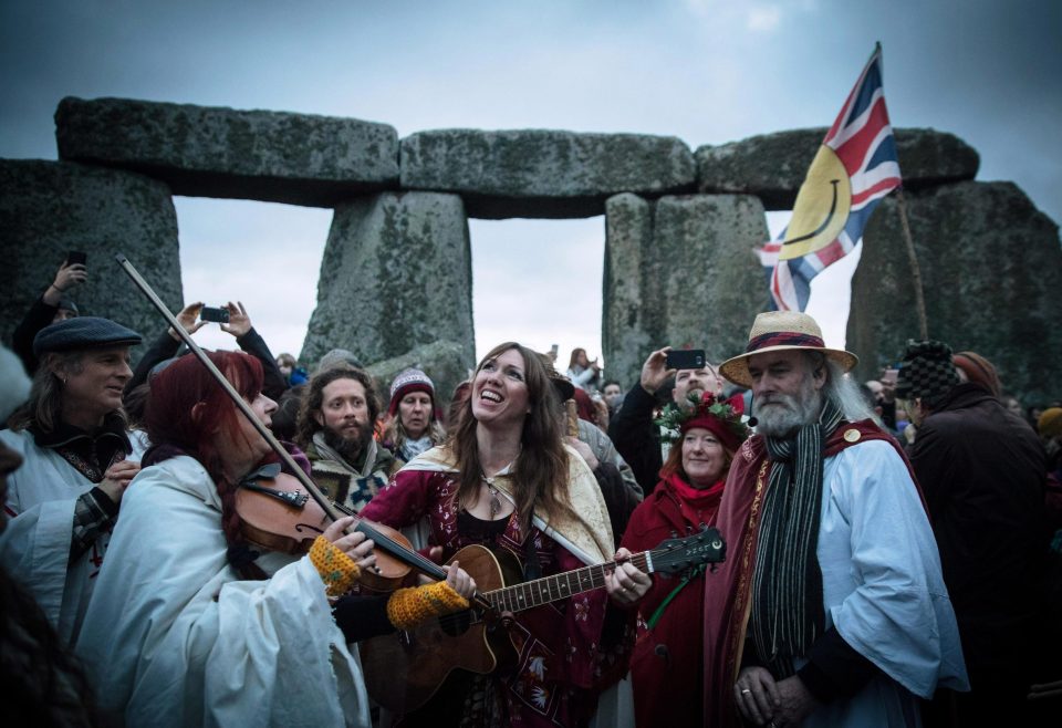  Druids play guitar and fiddle after celebrating the sunrise together