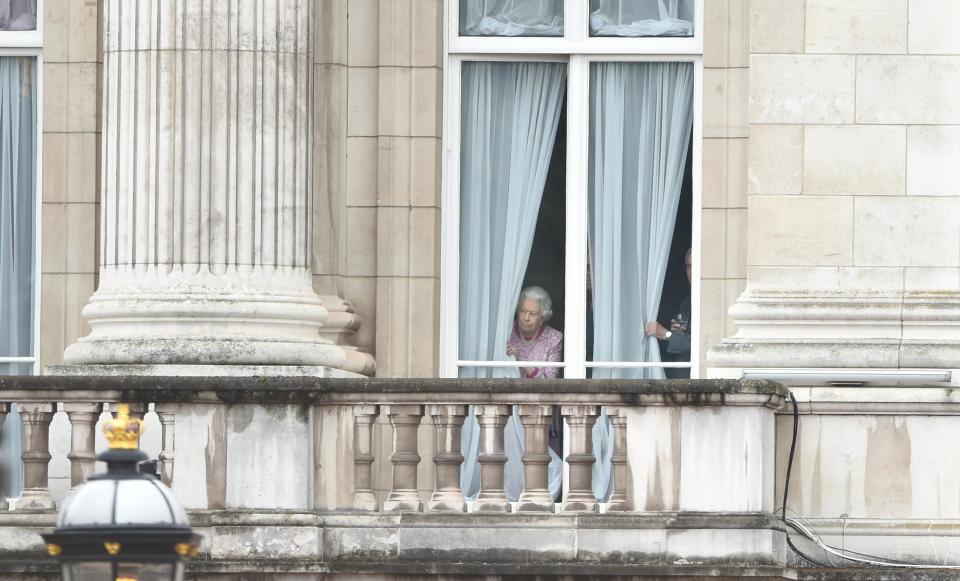  The Queen peeks out of the window at Buckingham Palace on her 90th birthday