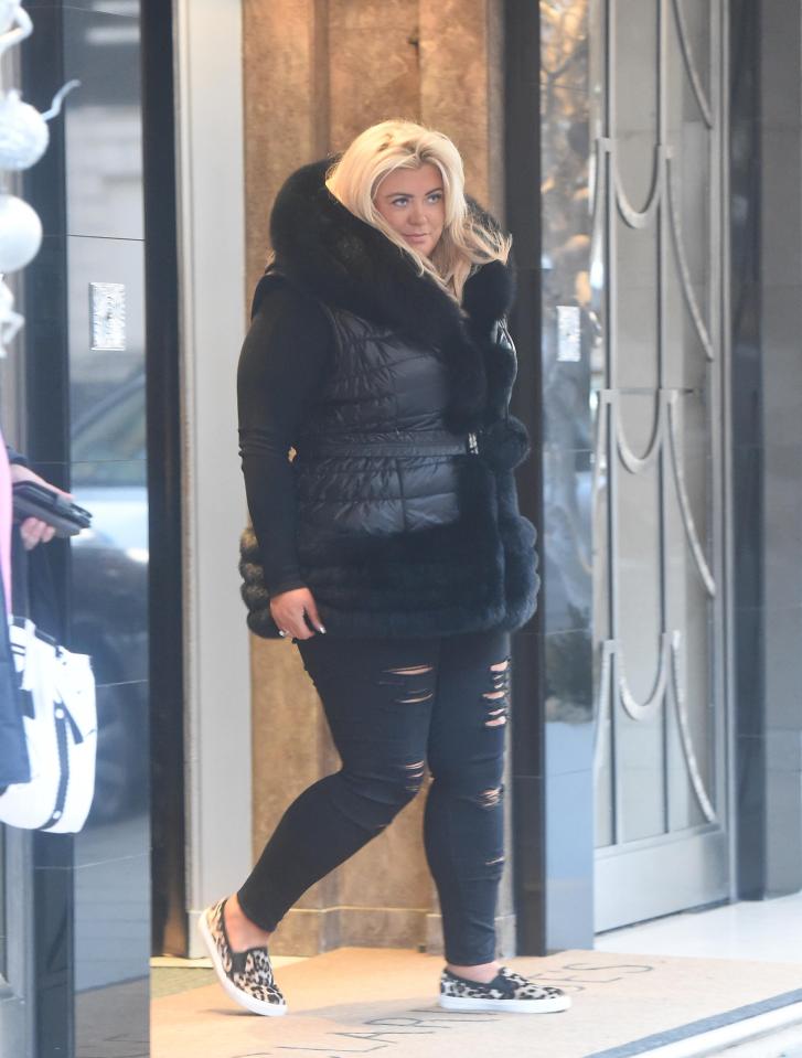  Gemma posed in a black gilet featuring a stylish fur trim at the luxury hotel