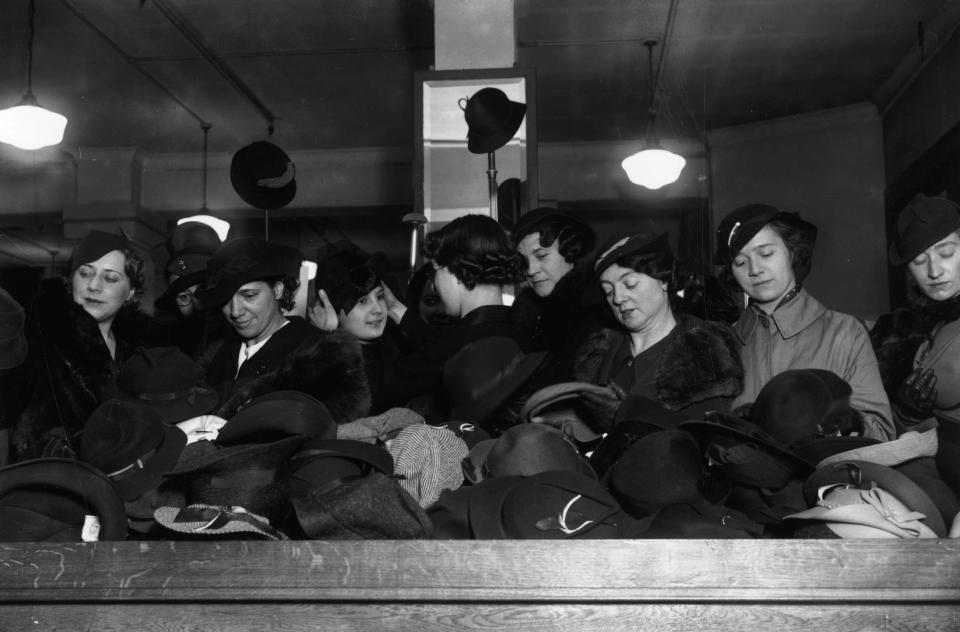  1935: A crowd of bargain hunters shopping for hats in the January sales at Whiteley's department store, Bayswater, London