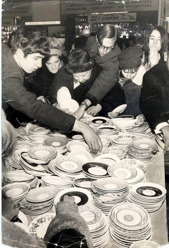  1960s: People make a grab for the crockery at Selfridges Department Store sale, London