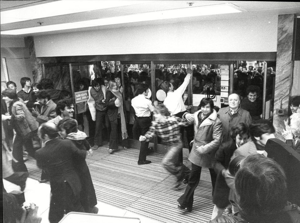  1977: Crowds of shoppers race into Debenhams Department Store for start of their sale