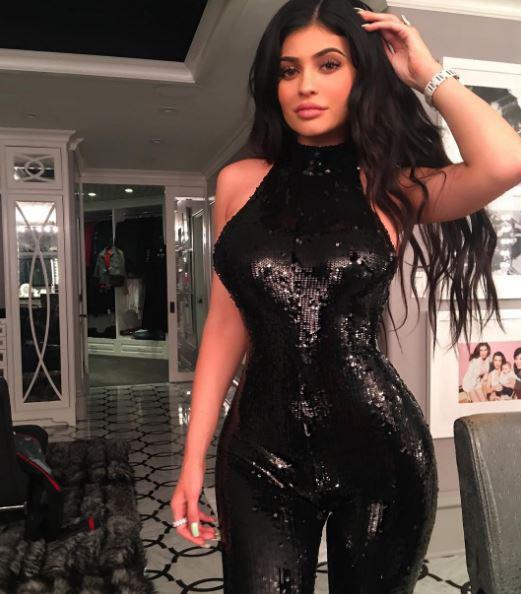  Khloe wore a black sequinned catsuit which showed off her hourglass figure