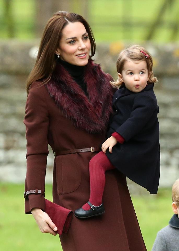  Kate carries Princess Charlotte into the church service in Berkshire