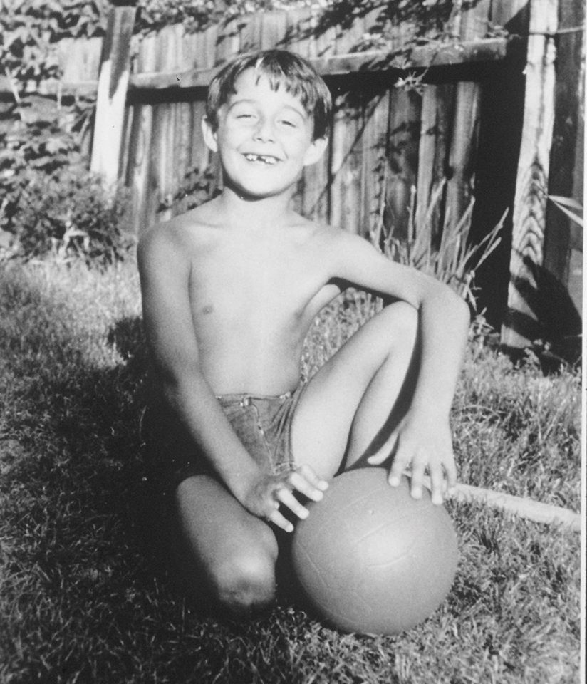  George Michael poses with a ball in his garden as a child