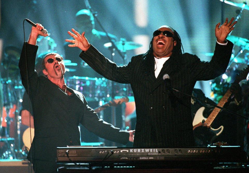  George Michael performs with Stevie Wonder in 1997