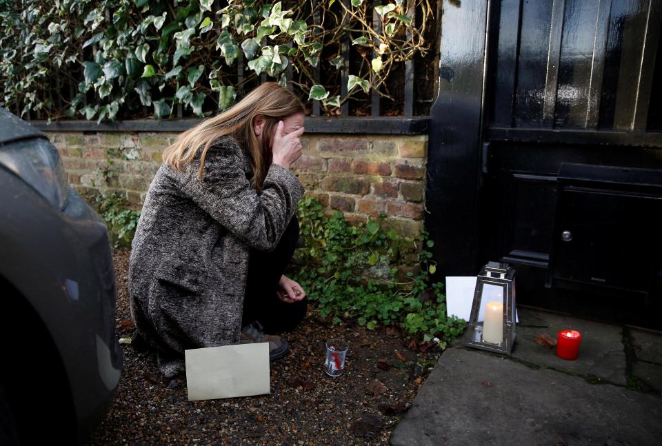  A woman breaks down in tears outside the London home of George Michael this morning