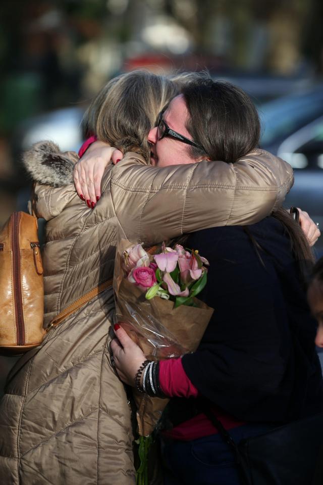  Two fans comfort each other as they pay tribute to the music legend today