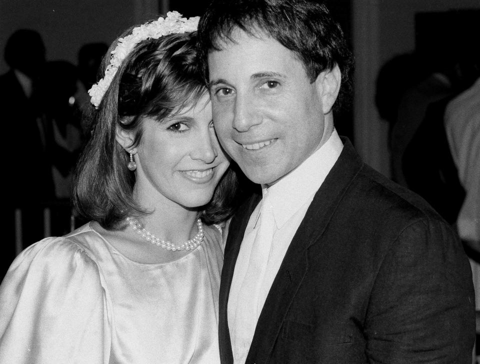  Fisher had a long on and off relationship with singer-songwriter Paul Simon, pictured