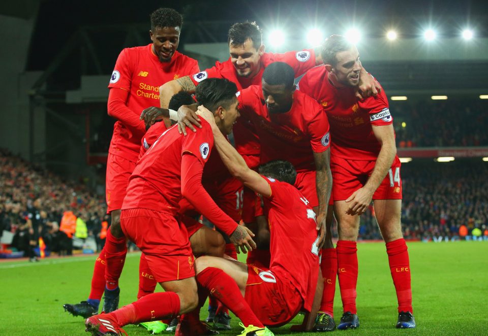 Roberto Firmino is then mobbed by the rest of his Liverpool team-mates after scoring