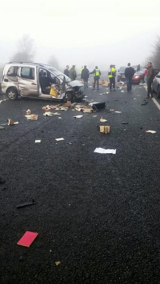  Emergency services consult people at the scene of the crash