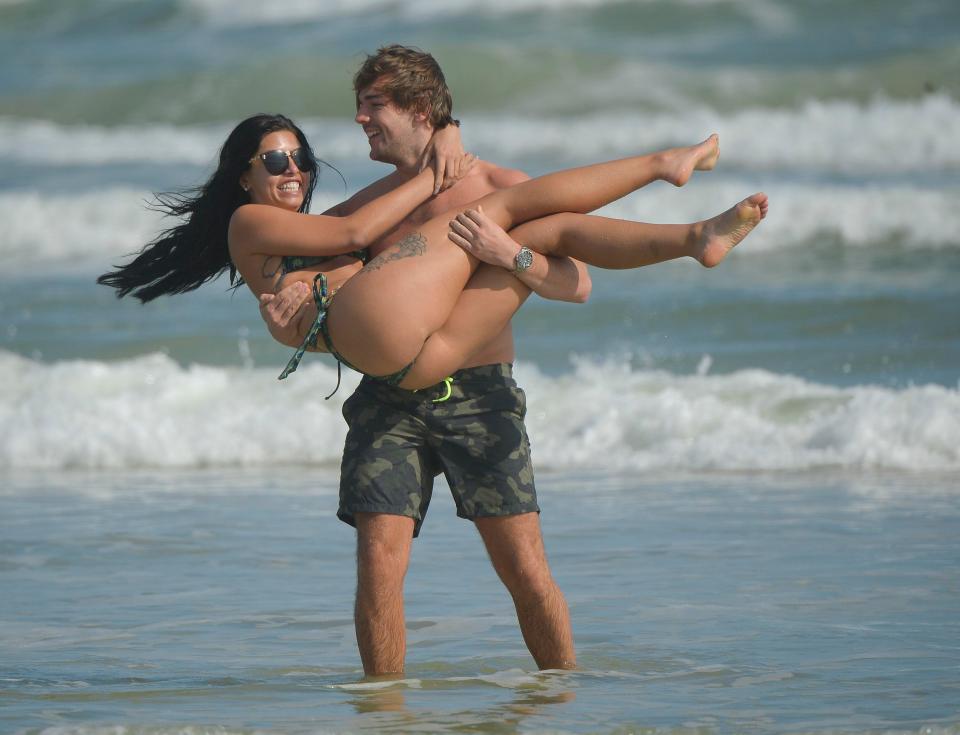 Car De La Hoyde and Nathan Massey look loved up as they splash in the seas in Florida