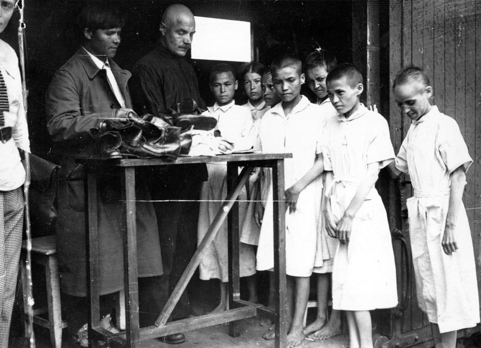  Children from famine stricken Chuvashia being given shoes upon arrival in Moscow during the Russian Civil War in 1921